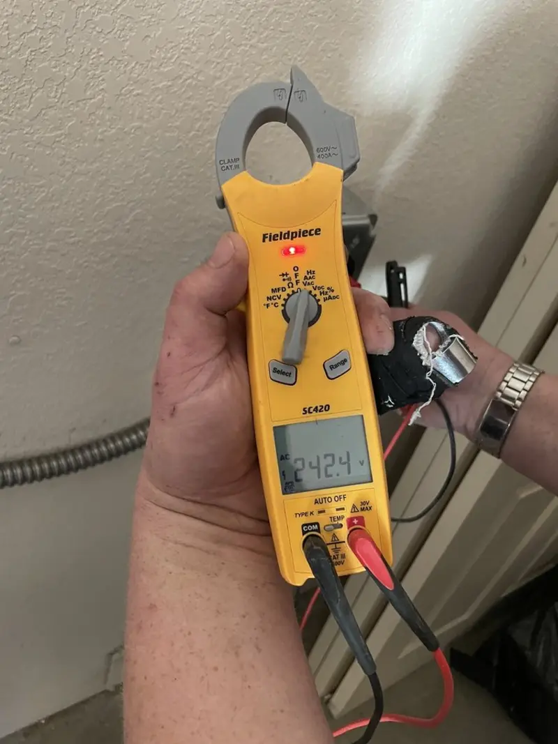 Voltage testing with clamp meter during Electrical Installation Services in Sioux Center